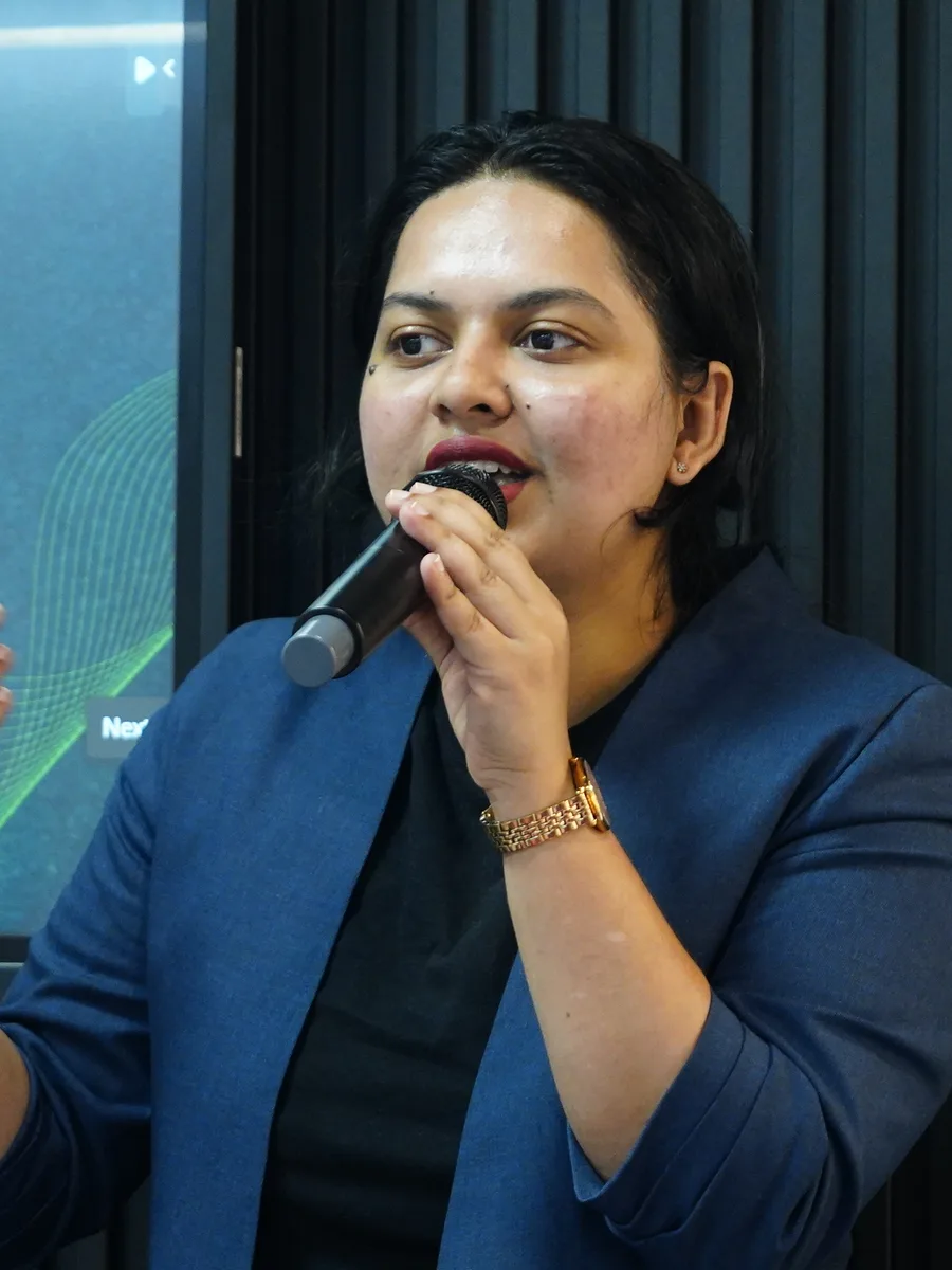 Mid-talk, microphone in hand